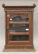 An Eastern carved hardwood glazed display cabinet. 68 cm high.