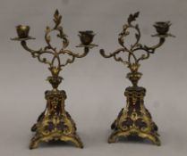 A pair of 19th century tortoiseshell and ormolu candelabra. Each 31 cm high.