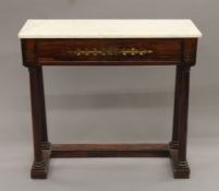 A 19th century marble-topped brass-inlaid rosewood console table with secretaire drawer.