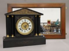 A Victorian black slate mantle clock and a mirror. The former 35 cm wide.