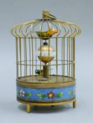 A cloisonne bird cage clock. 19 cm high.