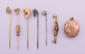 A collection of stick pins (the shield shape stickpin marked 9 ct gold (1.