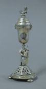 A Russian silver caster, the stem formed as a cellist. 15 cm high. 88.3 grammes.