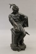 A large patinated bronze sculpture of a seated Continental gentleman with feathers in his cap.