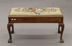 An early 20th century tapestry-topped walnut duet stool. 90 cm long.