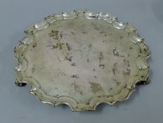 A large silver salver engraved with a crest. 30.5 cm diameter. 28 troy ounces.