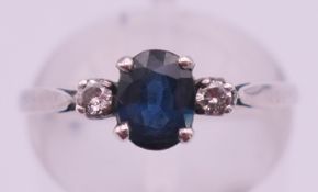 A silver diamond and sapphire dress ring. Ring size N.