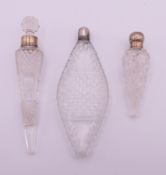 Three silver-mounted cut glass scent bottles. 8 cm, 12.5 cm and 13 cm high.