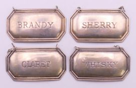 A set of four silver decanter labels (Claret, Sherry, Brandy and Whisky). Each 52 mm x 28 mm.