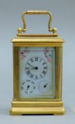 A miniature carriage clock with porcelain panels. 10 cm high overall.