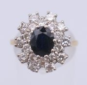 An 18 ct gold, diamond and sapphire ring. Ring size P. 5.7 grammes total weight.