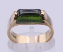 A 9 ct gold and peridot ring. Ring size G/H. 3.5 grammes total weight.