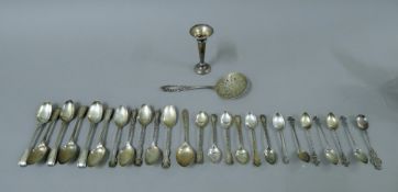 A quantity of silver spoons and a silver bud vase. The bud vase 11 cm high. 495.