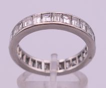 A platinum and diamond eternity ring. Ring size R. 6.3 grammes total weight.