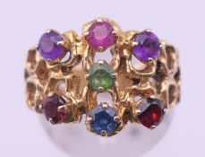 A 9 ct gold multi-gem set ring. Ring size L/M. 5.9 grammes total weight.