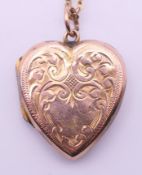 A 9 ct gold back and front heart locket on 9 ct gold chain. Locket 2 cm high, chain 47 cm long.