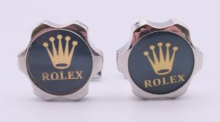 A pair of Rolex cufflinks in a Penrose of London box. 2 cm diameter.
