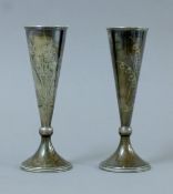 A pair of Russian silver bud vases decorated with floral sprays. Each 15.5 cm high. 158.5 grammes.