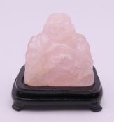 A rose quartz carving of Buddha on a stand. Buddha 4.5 cm high excluding stand.