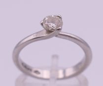 A platinum and diamond solitaire ring, the stone spreading to just under 0.5 ct. Ring size N. 4.