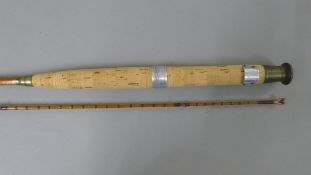 A 9' J & S Walker two-piece split cane fly rod in a canvas sleeve.