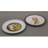 Two Russian porcelain plates, one decorated with a clown, the other with figures before a castle.