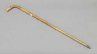A walking stick with enamel and gilt metal eagle-form handle. 91.5 cm high.