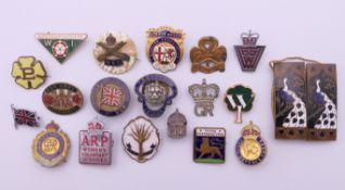 A collection of badges (Welsh Guards, British Legion, Girl Guides, Comrades of the Great War,