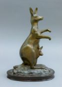 A bronze model of a kangaroo and joey mounted on a wooden plinth base. 22 cm high.
