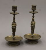 A pair of 19th century brass figural candlesticks. 24 cm high.