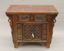 A 19th century Chinese elm side cupboard. 111 cm wide x 85 cm high x 79 cm deep.
