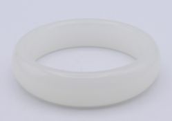 A white jade bangle. 2 cm high, 6.3 cm internal diameter.