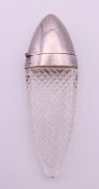 A silver-topped cut glass scent bottle. 10 cm high.