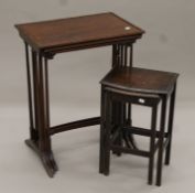 A Victorian nest of three mahogany tables and a nest of two oak tables. The former 55.5 cm wide.