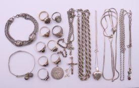 A collection of silver jewellery to include chains, a locket pendant on chain, a cross on a chain,