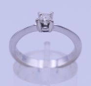 An 18 ct white gold and diamond solitaire ring. Ring size M/N. 3.5 grammes total weight.