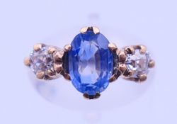 A 9 ct gold, sapphire and diamond three-stone ring. Ring size J/K.