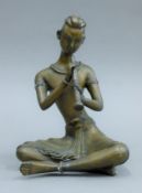 A bronze figure of a Thai flute player. 20 cm high.