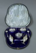 A cased Walker & Hall silver five-piece cruet set, with two associated silver salt spoons.