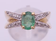 A 9 ct gold, emerald and diamond ring. Ring size N. 4.1 grammes total weight.