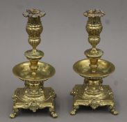 A pair of 18th/19th century Continental brass candlesticks with associated sconces. Each 23.