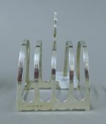 A silver toast rack. 7.5 cm long. 79 grammes.