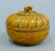 A small Chinese pottery lidded box. 8 cm diameter.