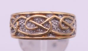 A 9 ct gold and diamond Celtic pattern ring. Ring size S. 7.3 grammes total weight.