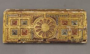 An antique carved, painted and gilded wooden panel, possibly Spanish. 49 cm long.