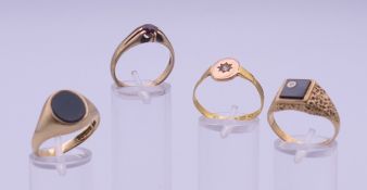 Three 9 ct gold rings and another gold ring possibly 15 or 18 and 9 ct.
