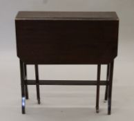 An Edwardian mahogany Sutherland table. 20 cm wide with flaps down.