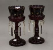 A pair of Victorian enamel-decorated ruby glass lustres. Each 30.5 cm high.