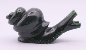A jade snail with gold and ruby eyes. 10 cm long.