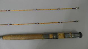 A 10' Hardy Bros two-piece split cane fly rod with spare end section in a Hardy canvas sleeve.